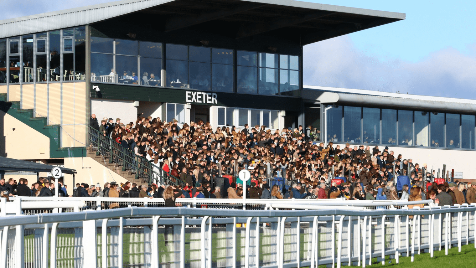 Spectators sitting in the stands at Exeter Racecourse