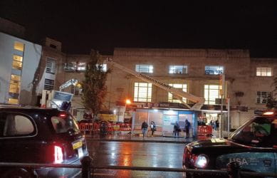 The stone cleaning process at Richmond station in action at night - South Western Railway