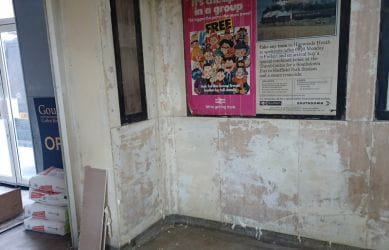 Travertine marble overpaint in the process of removal at Richmond station - South Western Railway