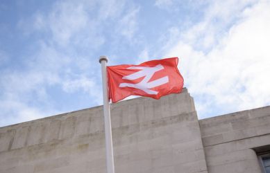 Flag of the National Rail logo outside Richmond station - South Western Railway