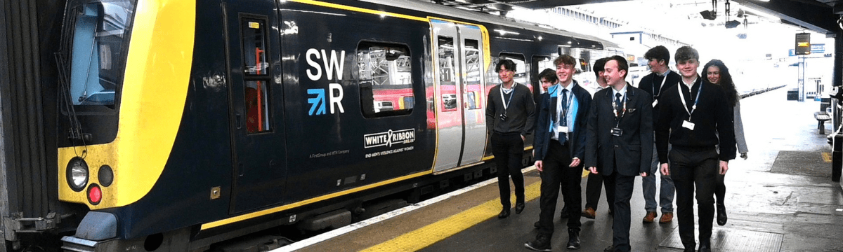 People walking along train platform