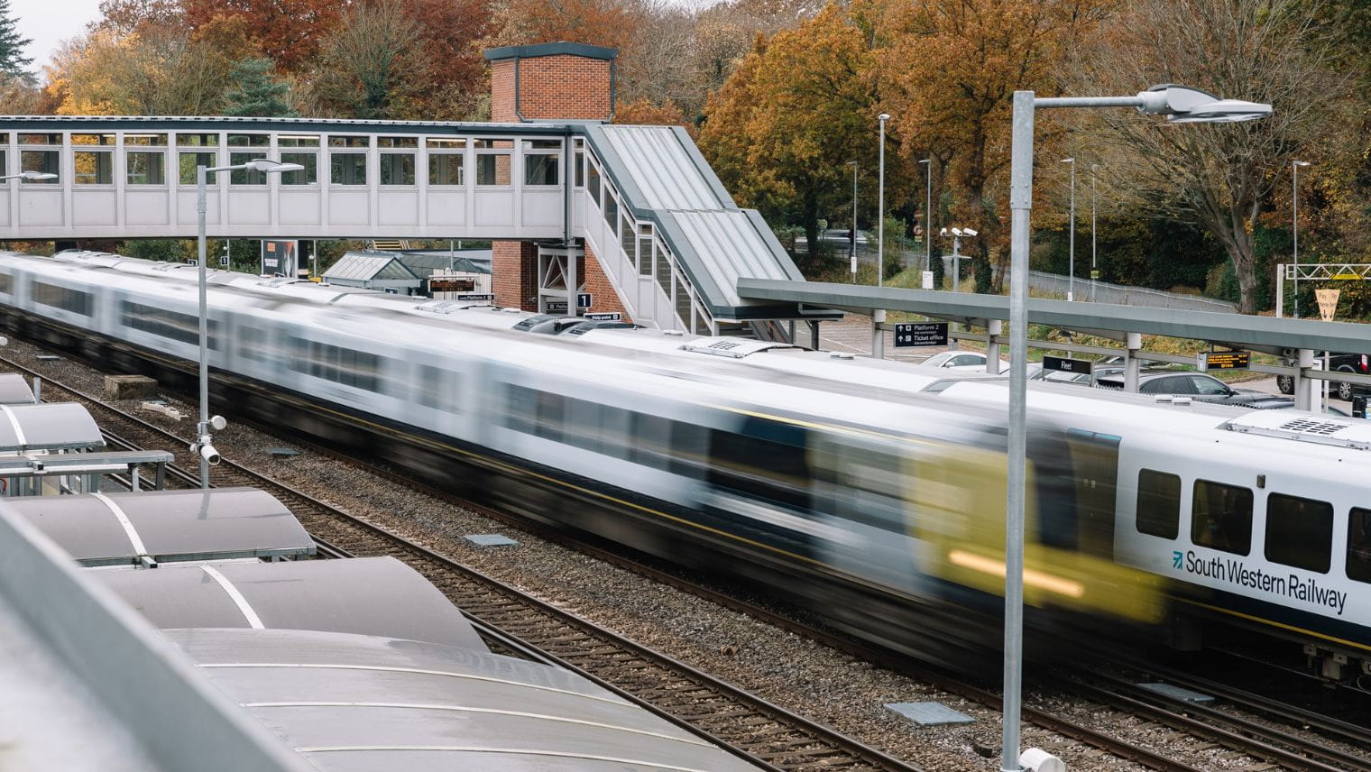 Class 450 train passing through Fleet station at speed