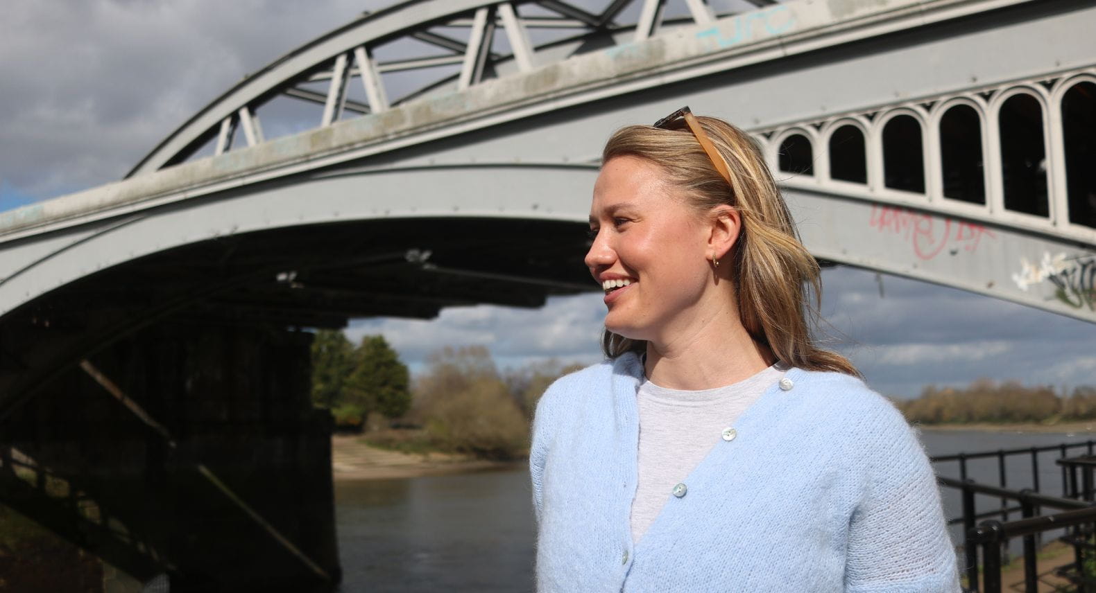 Blond woman standing in front of Barnes Bridge