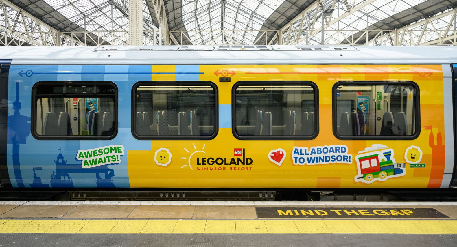 View of side of brightly coloured train advertising LEGOLAND Windsor