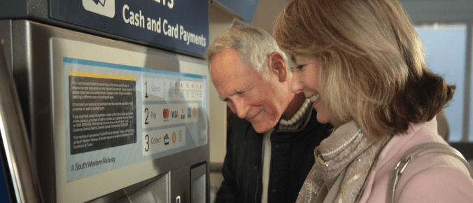 older couple purchase train ticket 
