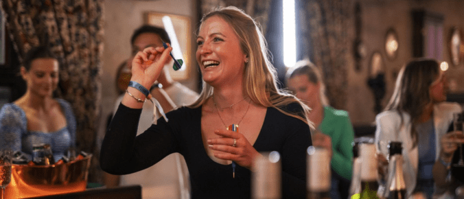 woman play darts in a pub
