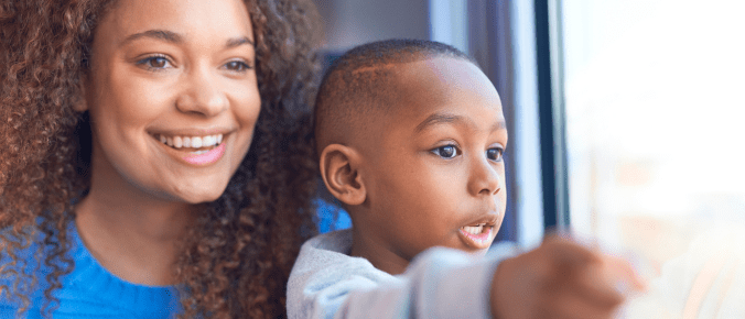 kids enjoy the train ride with his mum