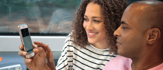 Couple looking at their phone in the train