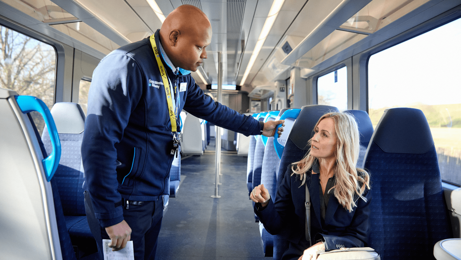 man assist a passenger on the train