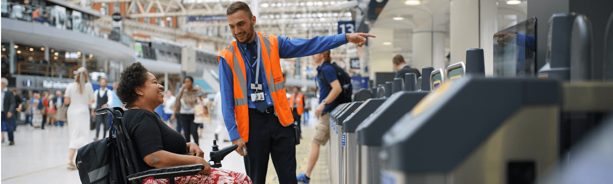 Wheelchair user being assisted at gateline