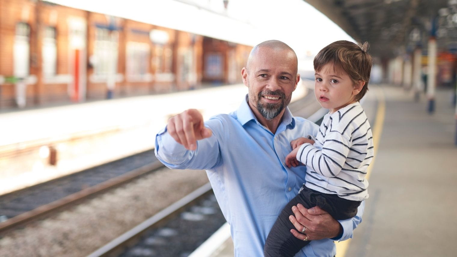 A parent and child in playful conversation on a train