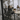 Team meeting around a conference table, with laptops, papers, and coffee cups visible.