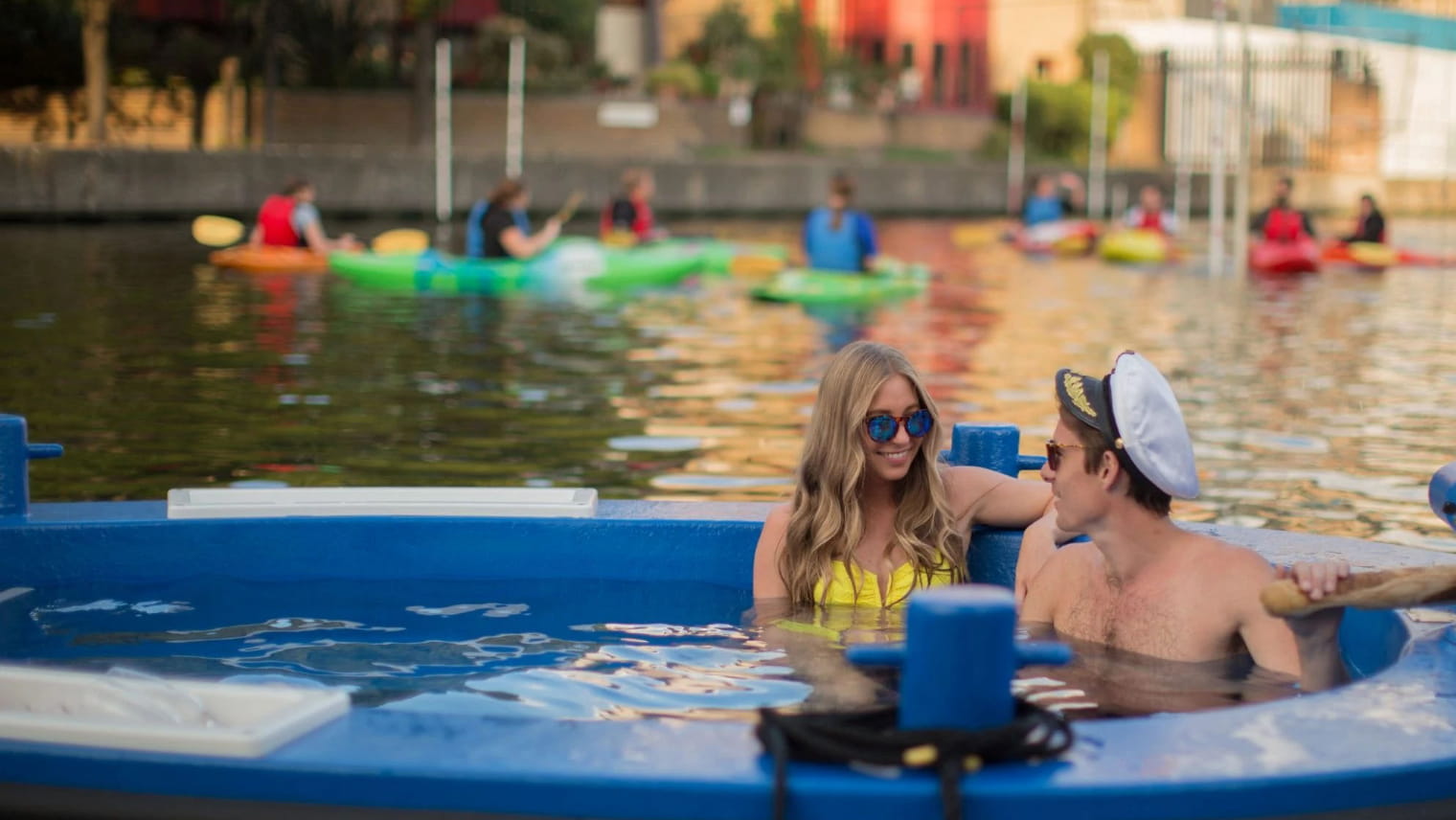 A couple in a floating hot tub on the Thames