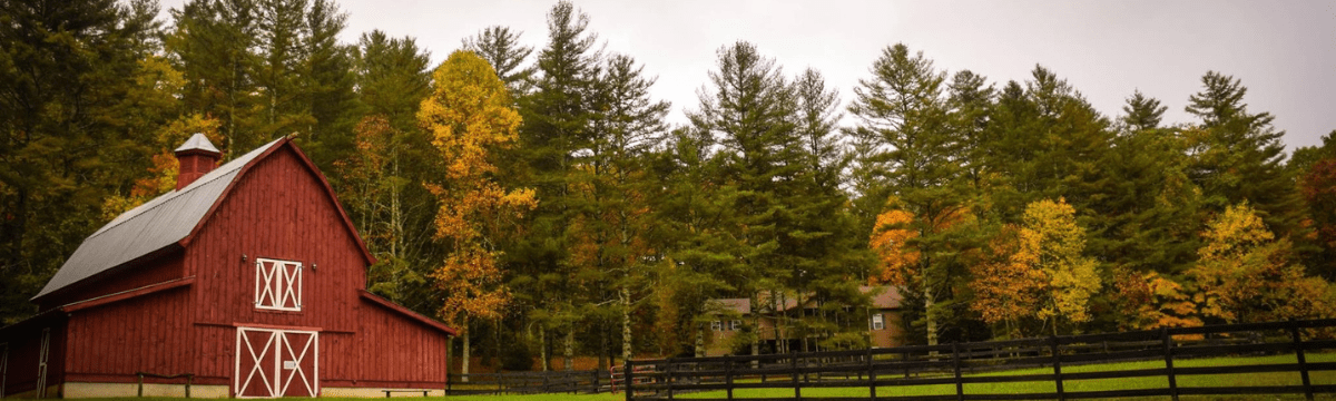 Image of a red farmhouse on green land