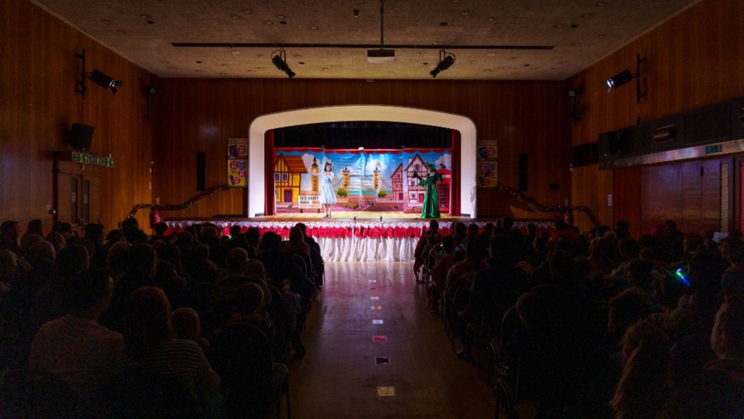 A performance on stage with an audience watching