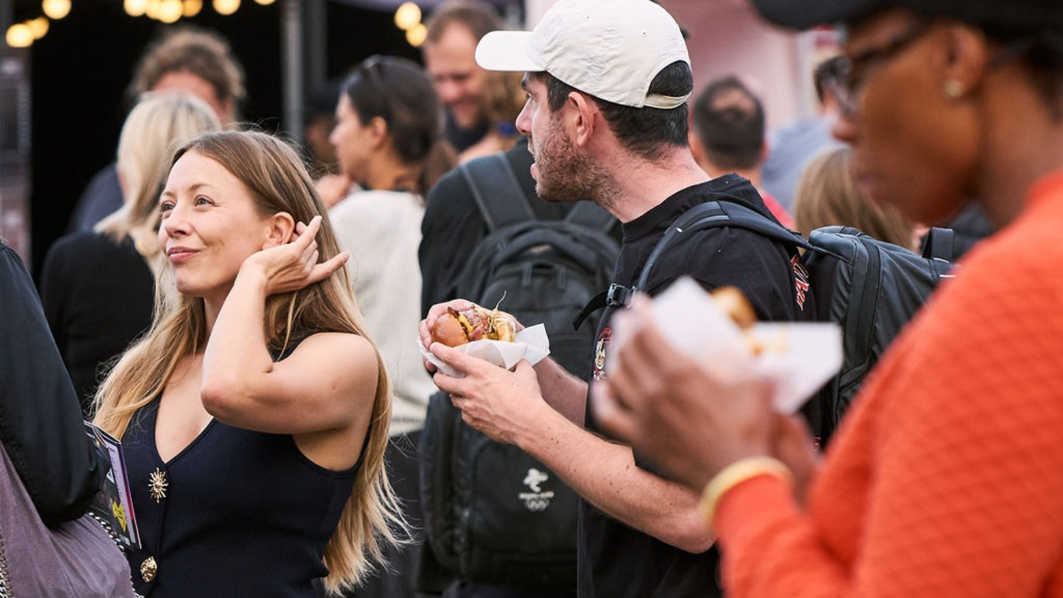 People enjoying food at the outdoor comedy festival area