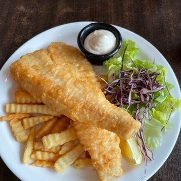 Fish and chips on a plate with salad
