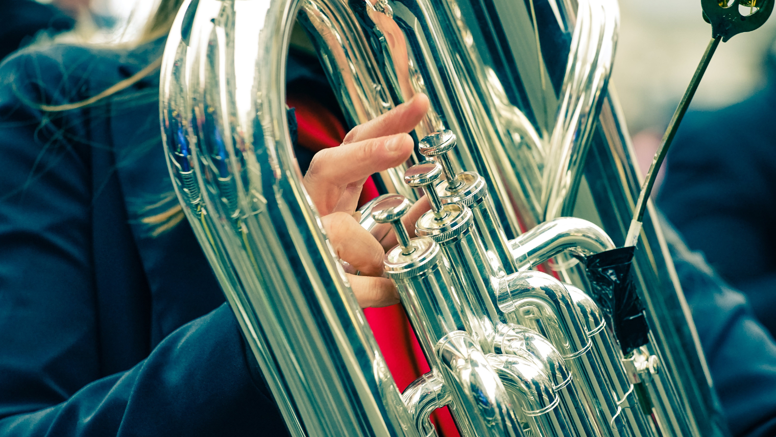 A person playing a brass instrument at a parade