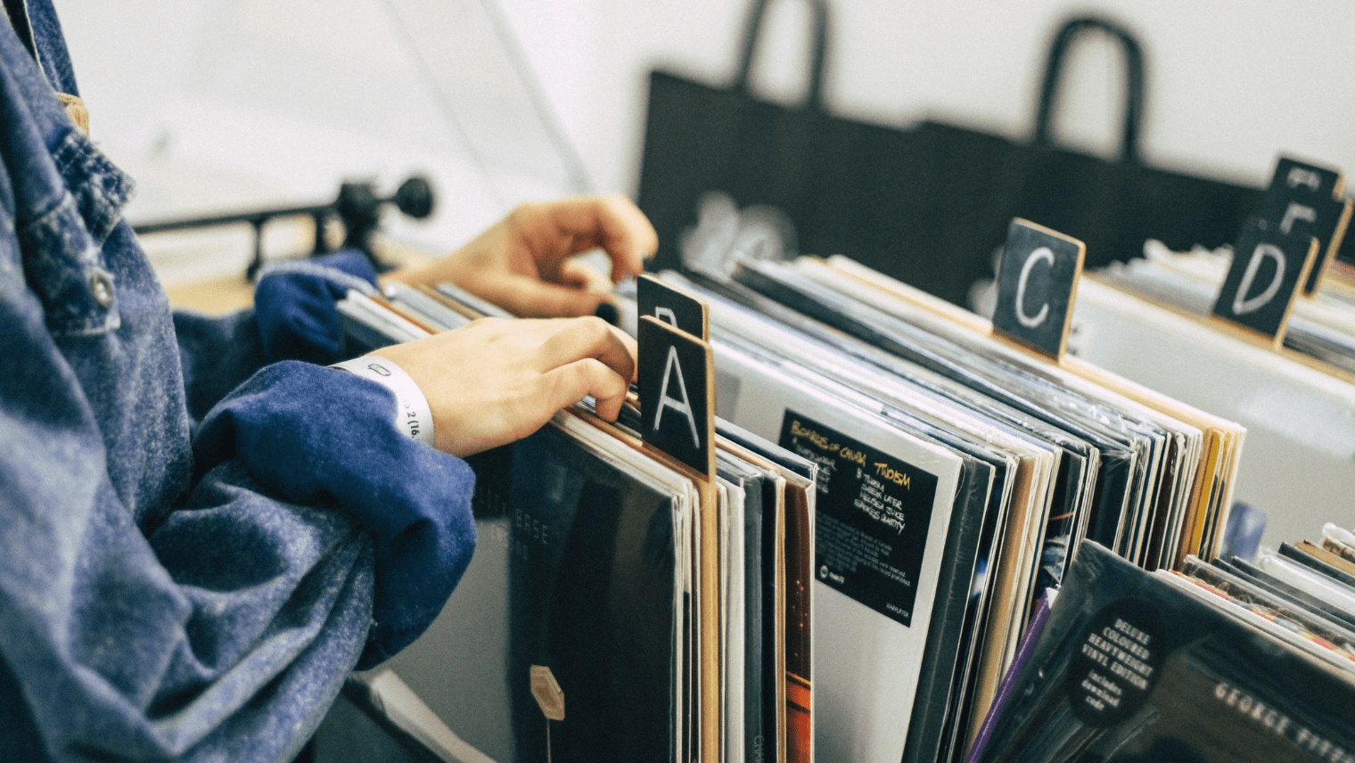 An image of a person looking at records at a record store