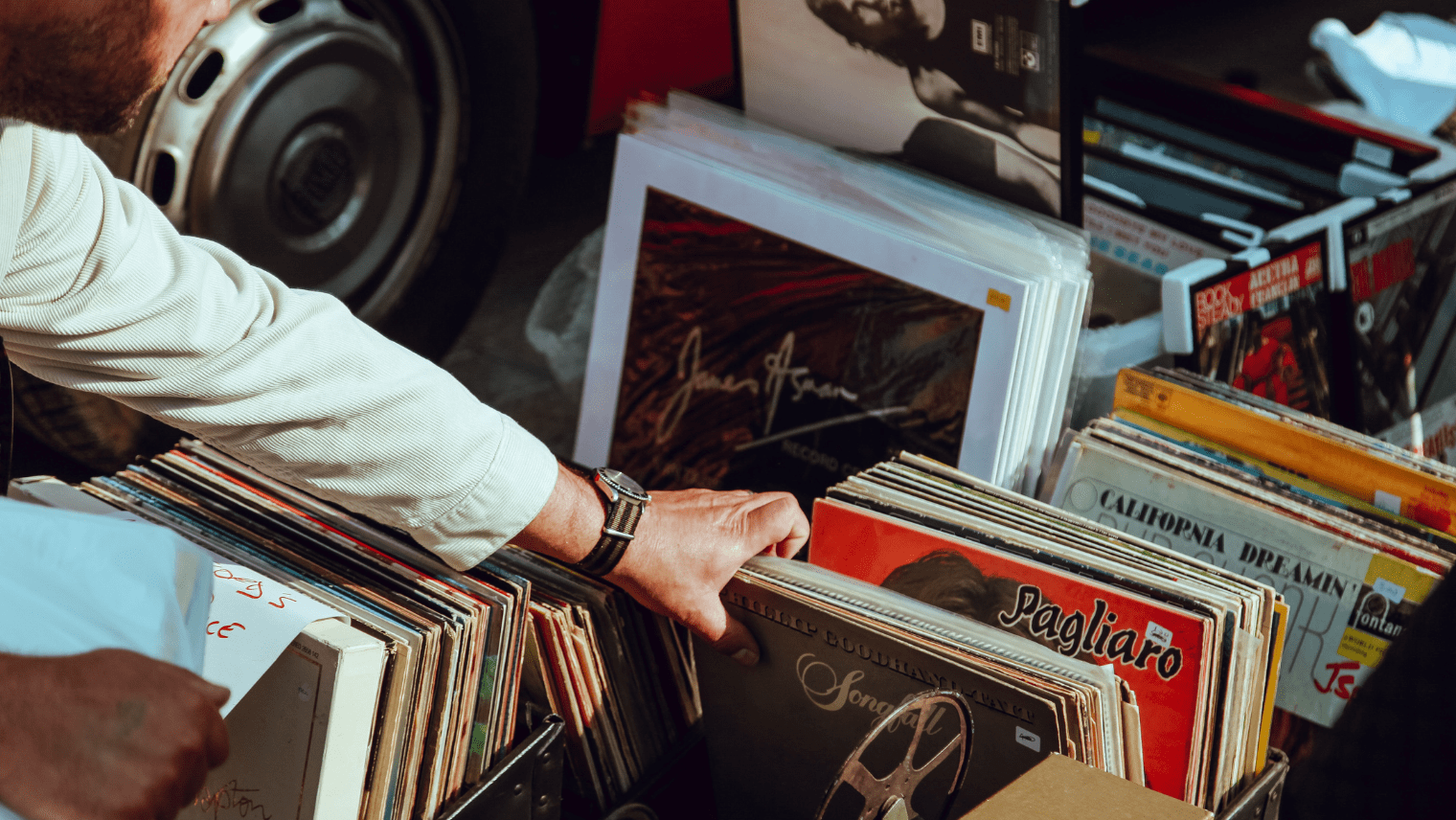 An image of someone looking at records at a record store