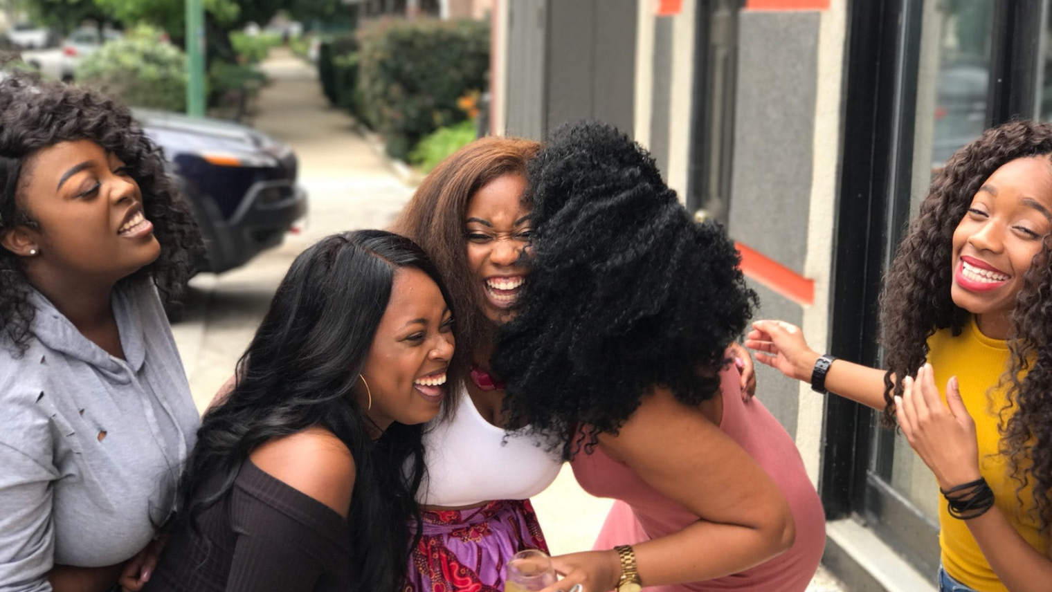 5 women laughing together