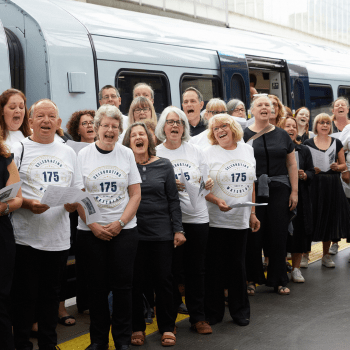 A group picture in front of a train