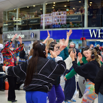 A crowd of people at a Waterloo Station silent disco