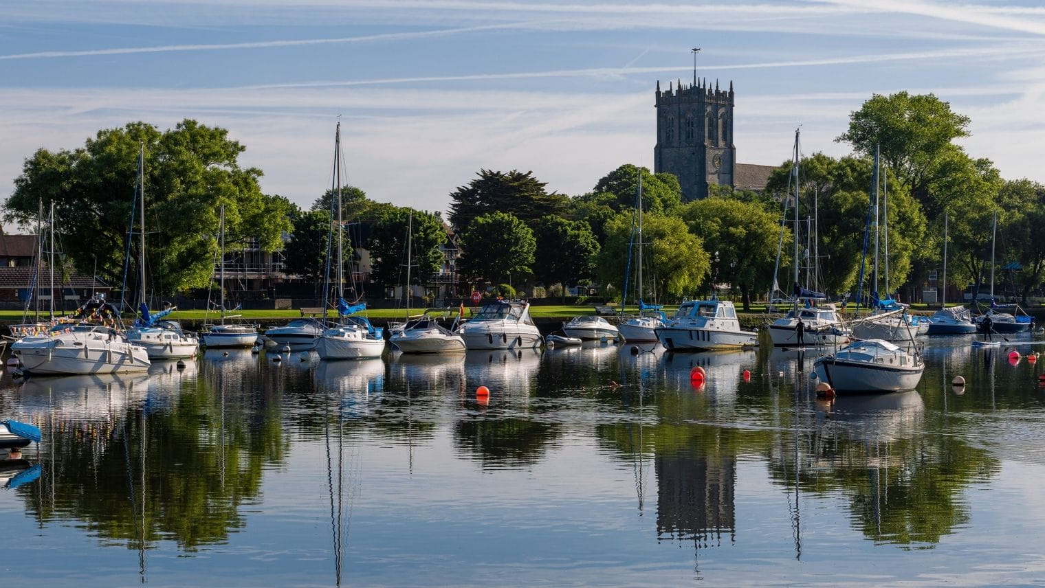 Parked leisure boats overlooked by the Priory