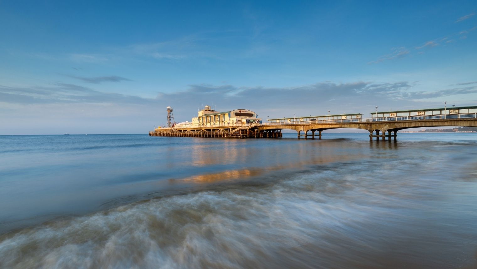 Bournemouth Pier seen from the beach at sunrise