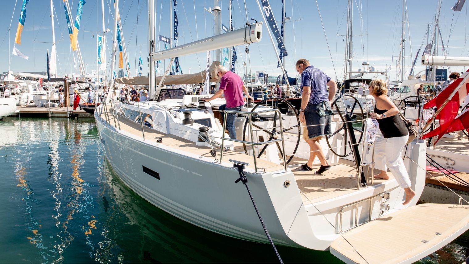 People stepping onto a boat at the Southampton International Boat Show